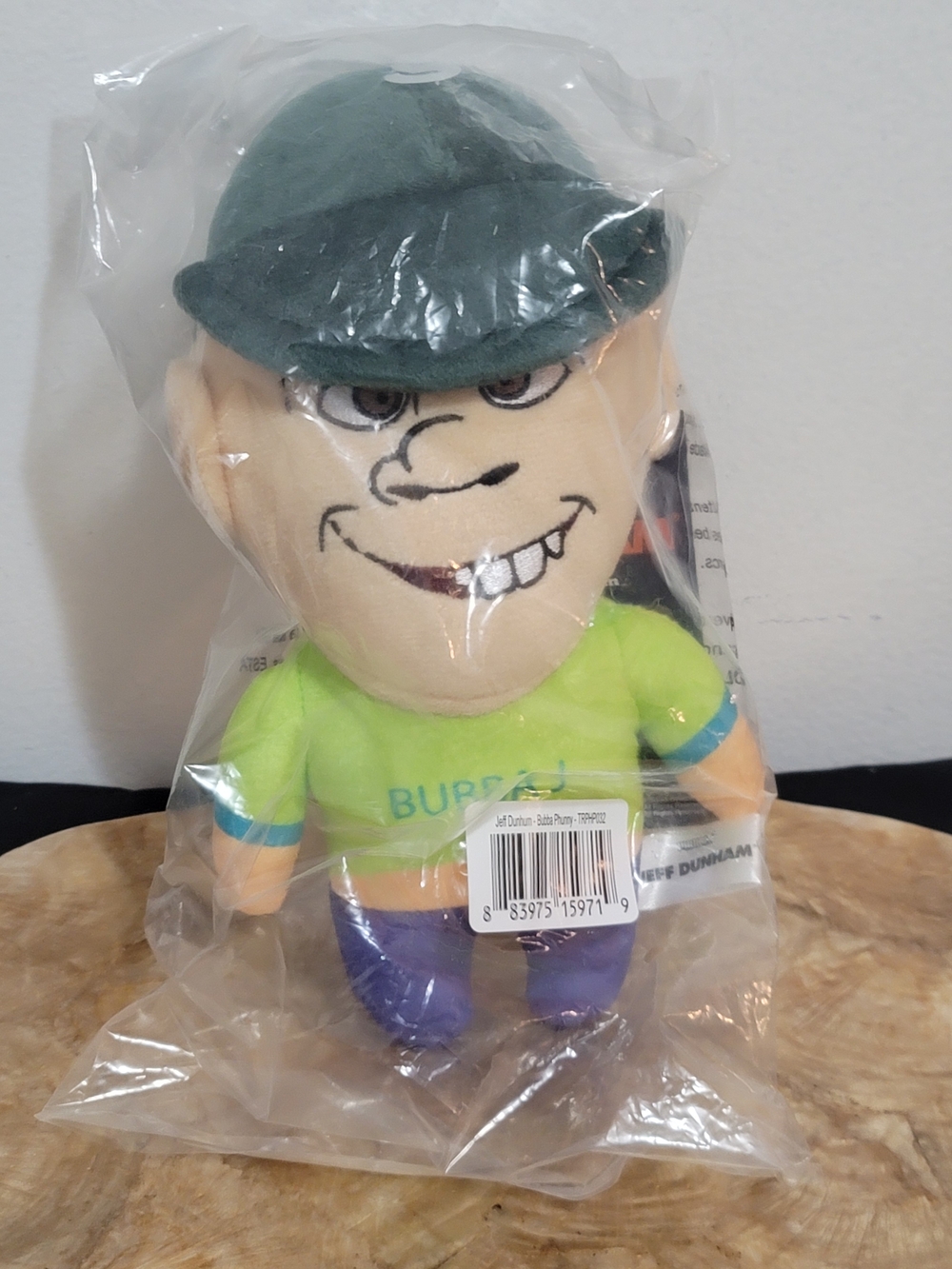 Plush Cartoon Character in Lime Green Shirt and Dark Green Cap